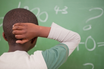 Black student doing math in school