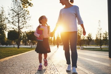 Mother and daughter walking to school