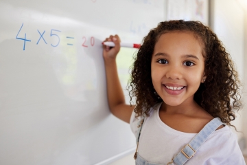 Student doing math in a classroom