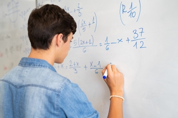 Student doing math in a classroom