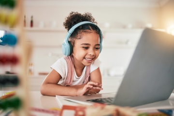 Child doing schoolwork on a computer at home