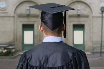 Graduate in a graduation cap and gown