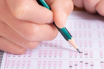 School student taking a standardized test with a scantron form