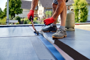 Working repairing a roof