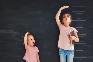 children measuring themselves