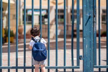 Student outside a closed school