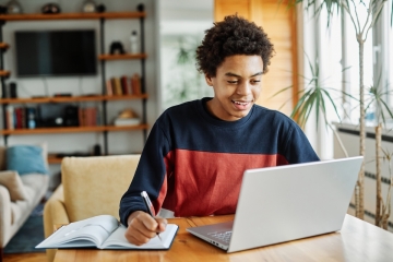Teenager doing homework on computer