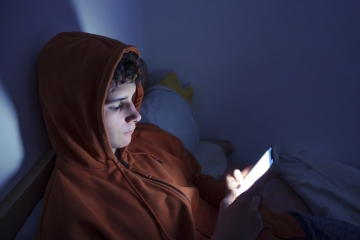 Teenager on phone at night