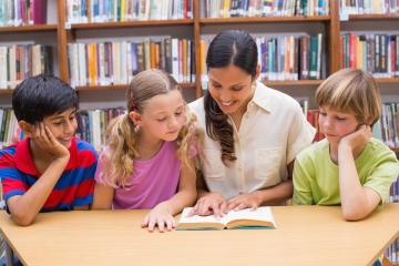 Children reading with teacher