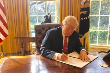 Donald Trump signing a bill