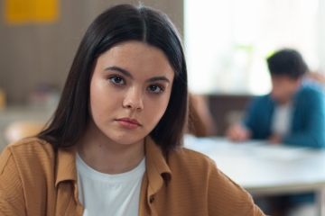 Serious portrait of a student in a classroom