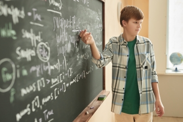 Student doing math in a classroom