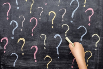 Question marks on a chalkboard