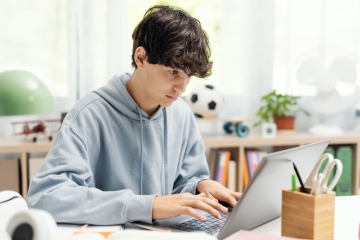 Teenager doing homework on computer