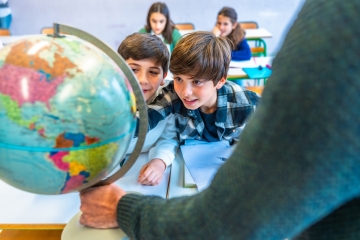Students looking at a globe