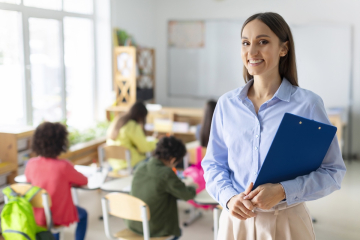 Happy teacher in a classroom