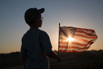 Child holding an American flag