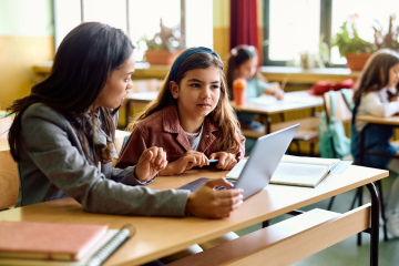 Teacher and student with a laptop