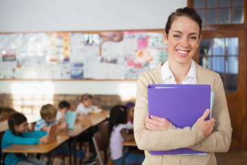 Happy teacher in a classroom