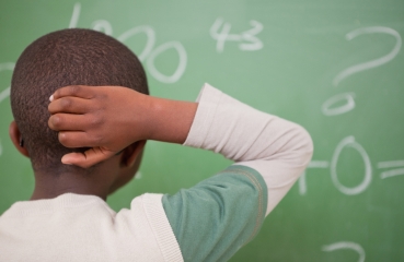 Black student doing math in school