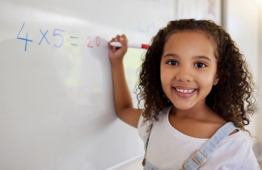 Student doing math in a classroom
