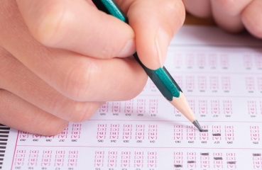 School student taking a standardized test with a scantron form