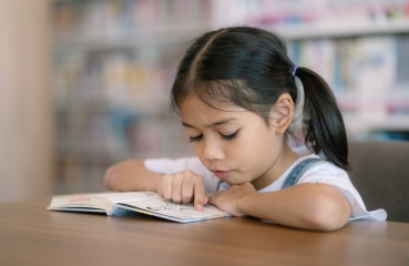 Child reading in school