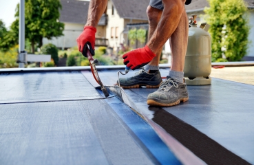 Working repairing a roof