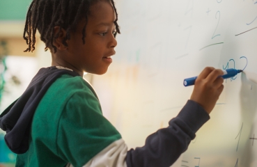 Student doing math in a classroom