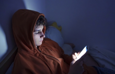 Teenager on phone at night