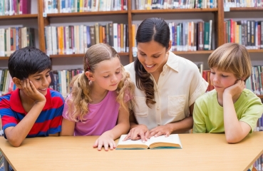 Children reading with teacher