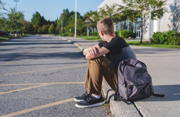 Student sitting alone outdoors
