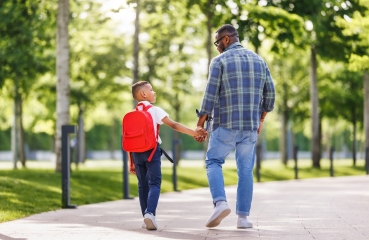 Father and son walking to school