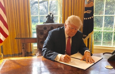 Donald Trump signing a bill
