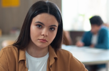 Serious portrait of a student in a classroom