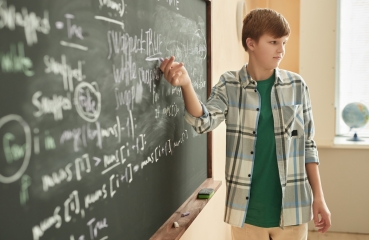 Student doing math in a classroom