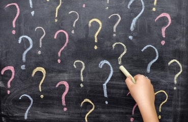 Question marks on a chalkboard