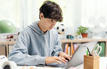 Teenager doing homework on computer