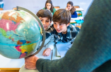 Students looking at a globe