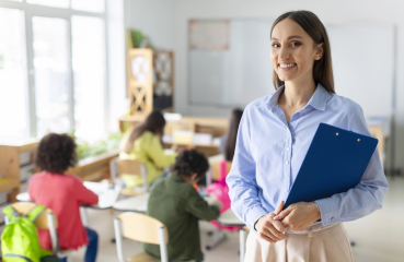 Happy teacher in a classroom