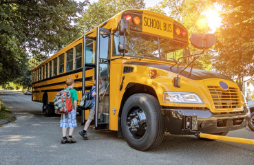 Kids boarding a school bus