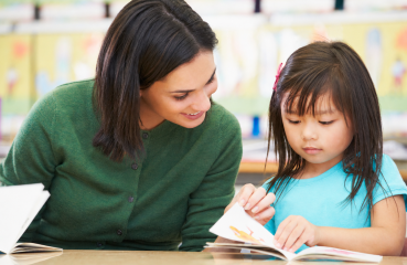 Teacher and a student reading