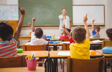 Teacher and classroom full of students