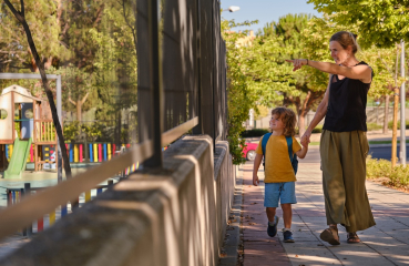 Parent and child outside playground