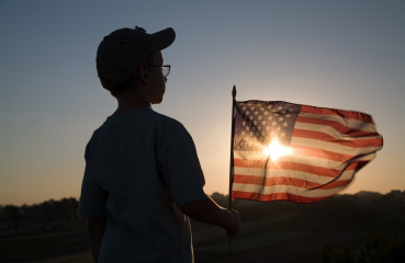 Child holding an American flag