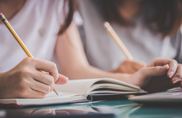 Students writing with pencil and paper