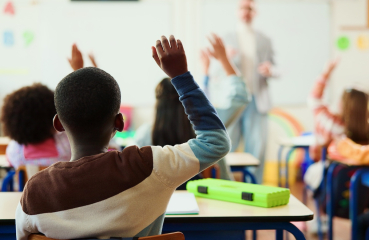 Students with hands raised