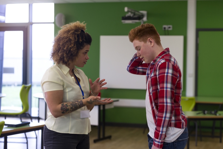 Teacher speaking to a student
