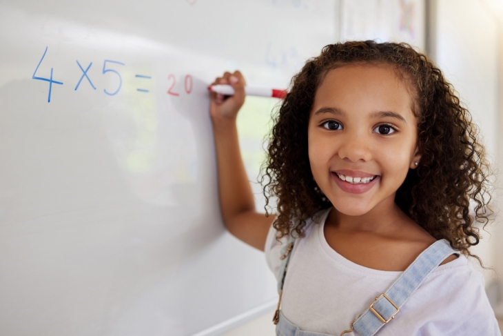 Student doing math in a classroom