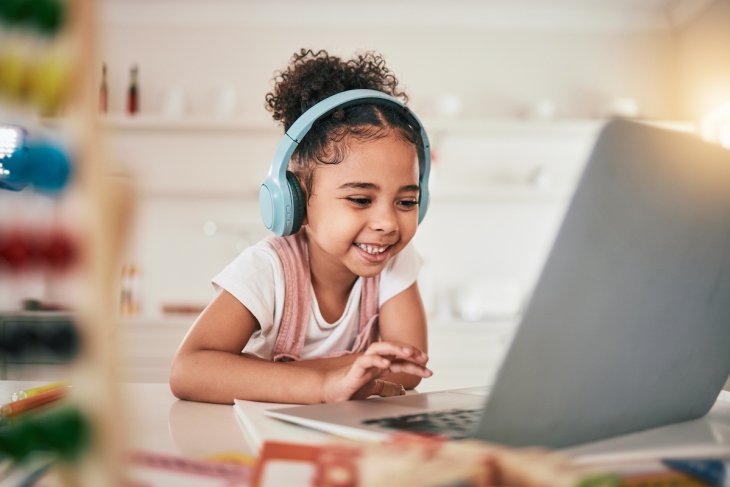Child doing schoolwork on a computer at home